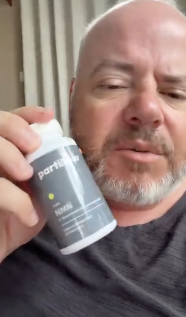 Customer holding his bottle of Pure NMN