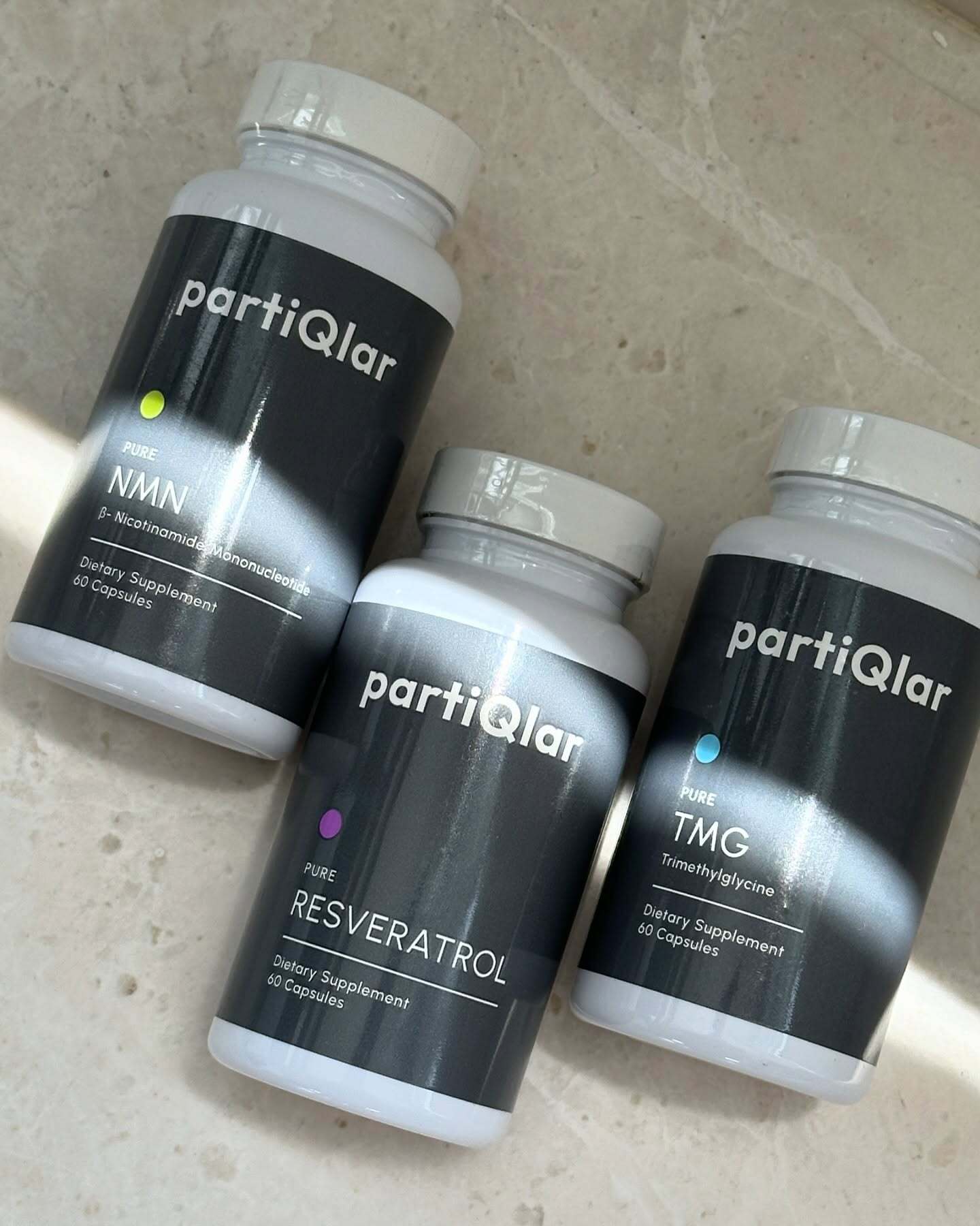 Customer's NMN, Resveratrol and TMG bottles on marble